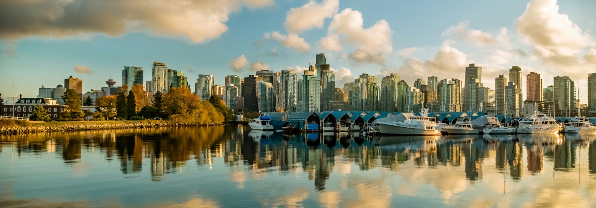 Apartment buildings beside the water under a pale sky.